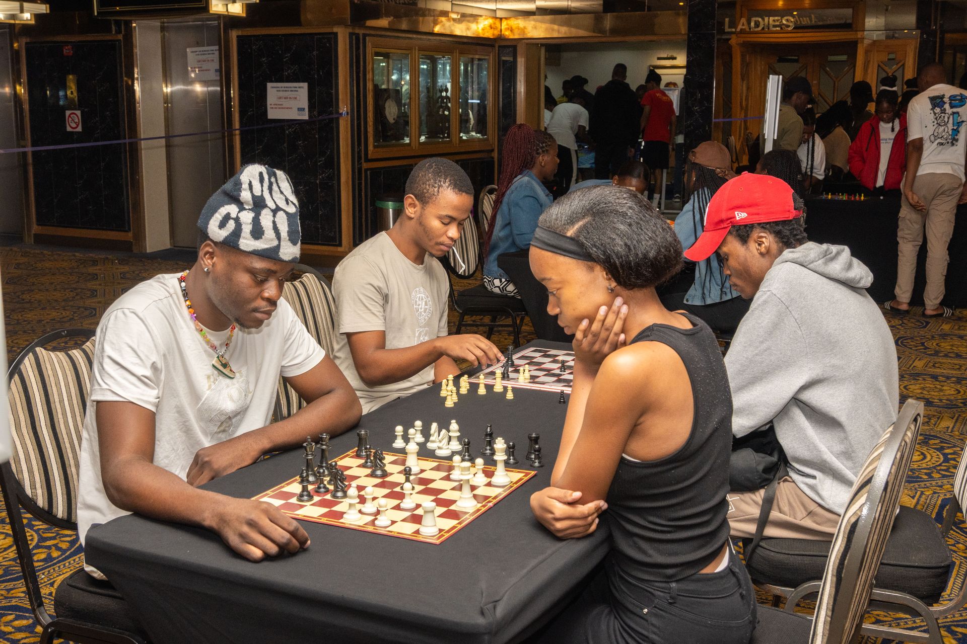 Students playing chess during a Res Life strategy night event in the lounge