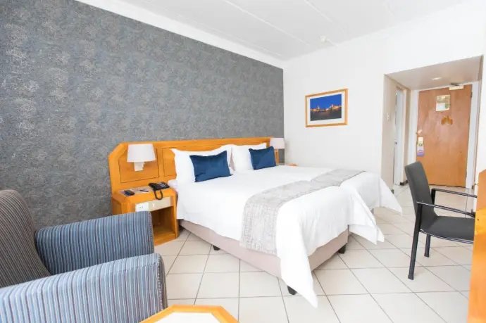 Private room with double bed, study area, and fridge