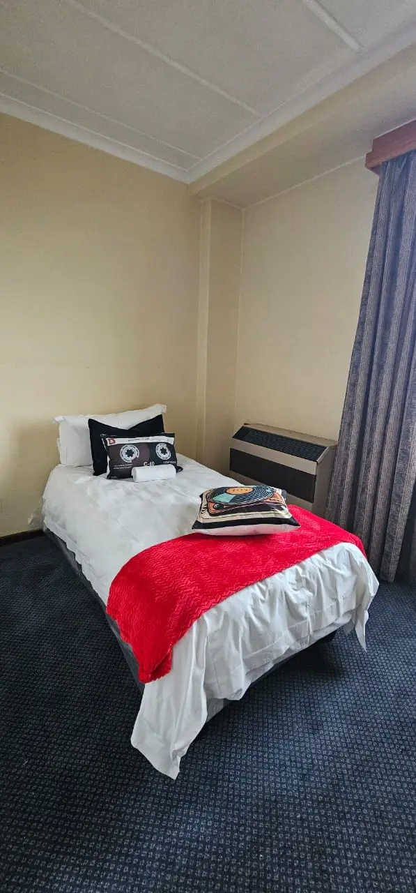 Two-sharing student room with divider and study desks at BPSH