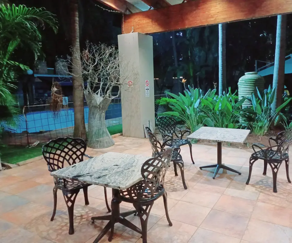 Indoor and outdoor communal seating areas with tables and chairs for students to relax or socialize at Burgers Park Student Hotel