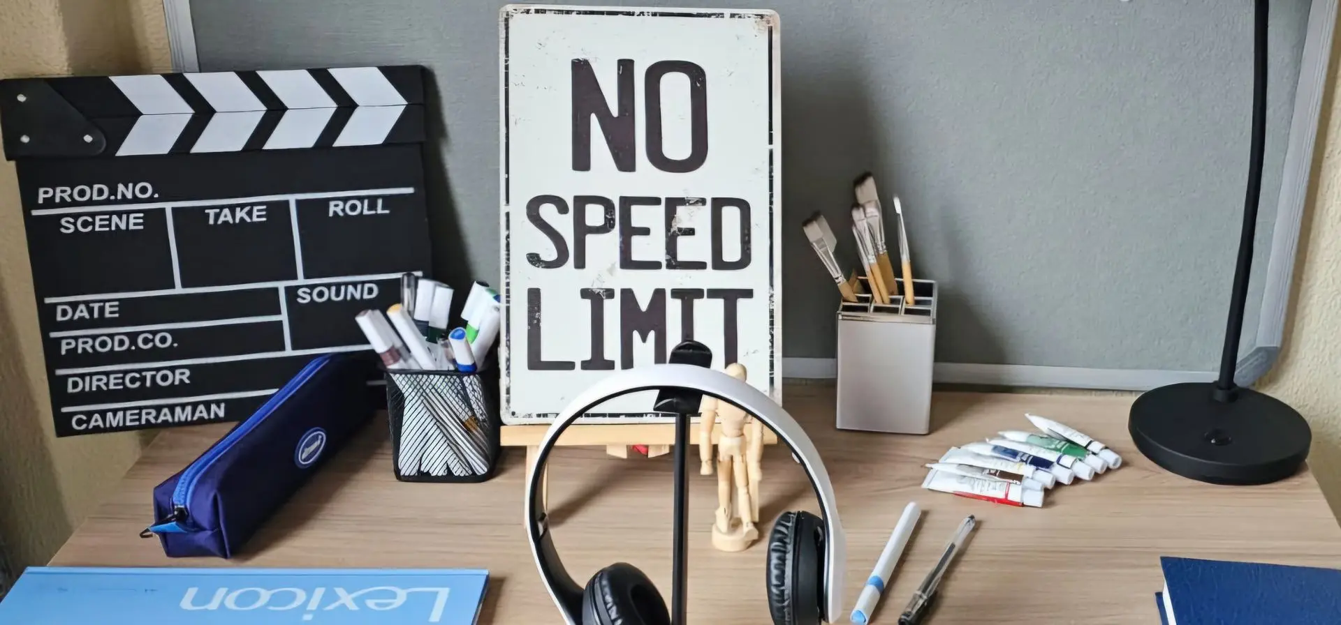 Creative student desk setup with movie clapperboard, art supplies, and inspirational decor at Burgers Park Student Hotel