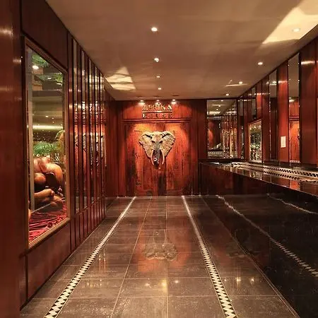 Historic entrance of Burgers Park Hotel with elephant carving and wooden décor