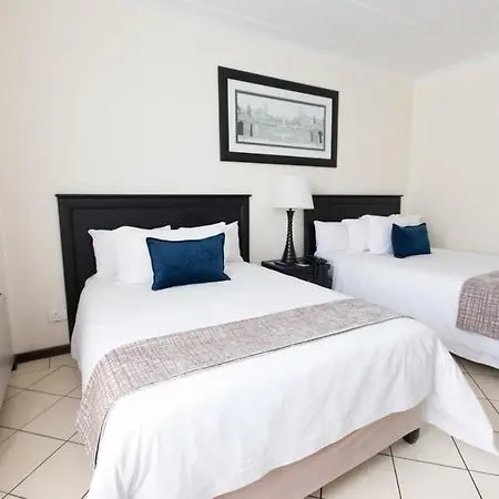 Double bed setup inside former Burgers Park Hotel room before conversion