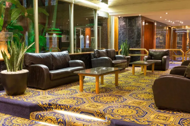Classic hotel lounge with leather sofas and coffee tables inside Burgers Park Hotel